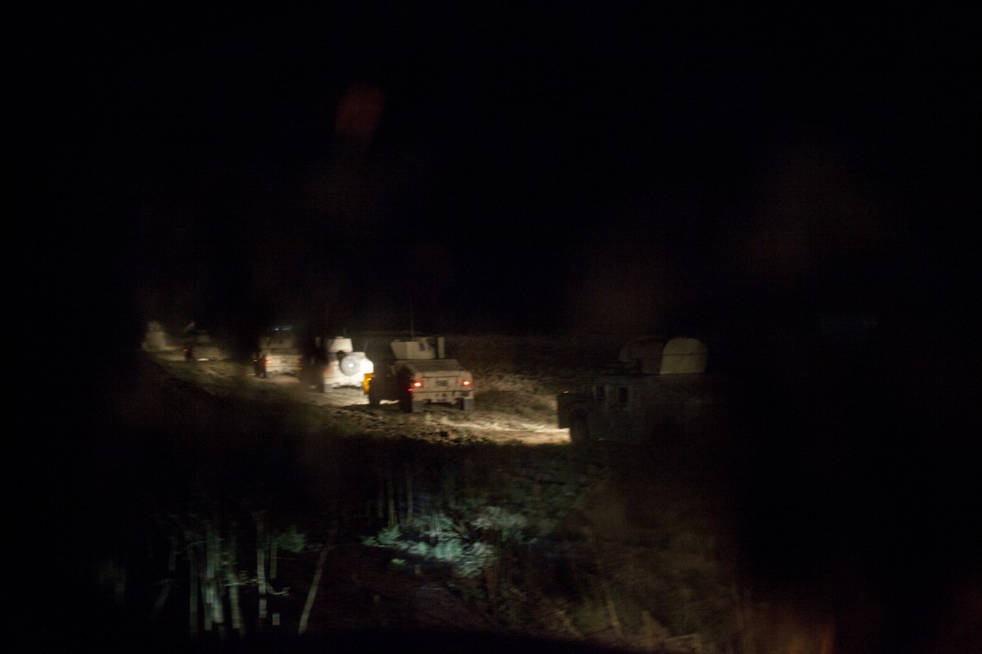 A convoy of Peshmerga militia tanks moving at night in a special operation from the military base to the Tuz Khurmatu front line. Tuz Khurmatu, Kurdistan, Iraq. June 20, 2017. The Peshmerga operation can go for up to 12 hours. Peshmergas guard the military base and must attack IS members infiltrated in the Peshmerga front lines. Moving is not easy, since the jihadists place mines to hinder access. The Peshmerga have to disable the mines to reach the battallions.