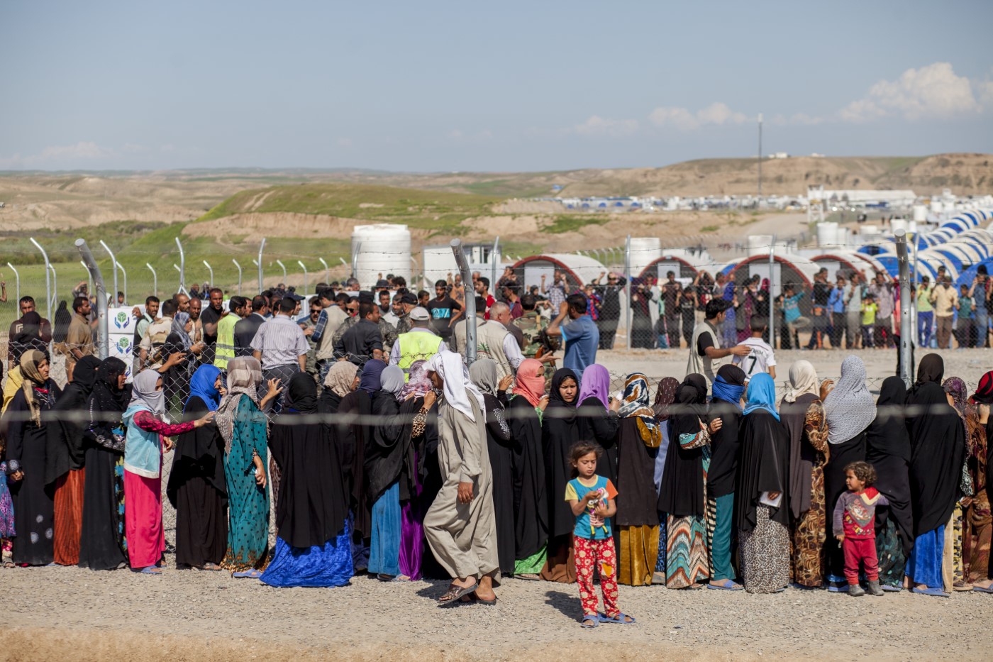 Displaced families from Mosul queuing desperately during a food supply inside the Hassan Sham Displaced Camp, Mosul, Kurdistan, Iraq. April 17, 2017
