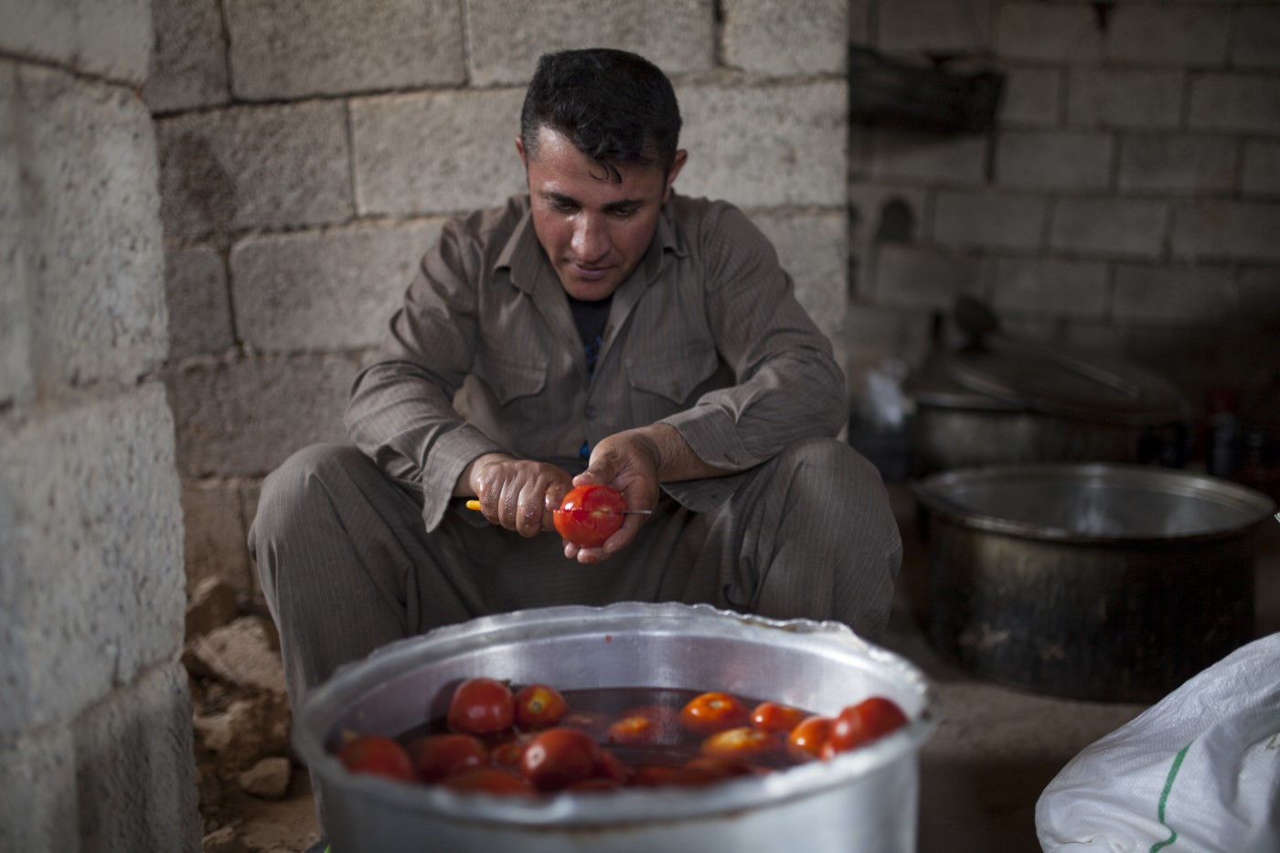 Peshmerga cooking dinner in one of the battalions of the front line located one kilometer from the Islamic State. Zarga, Tuzkhurmatu, Kurdistan, Iraq. August 11, 2017